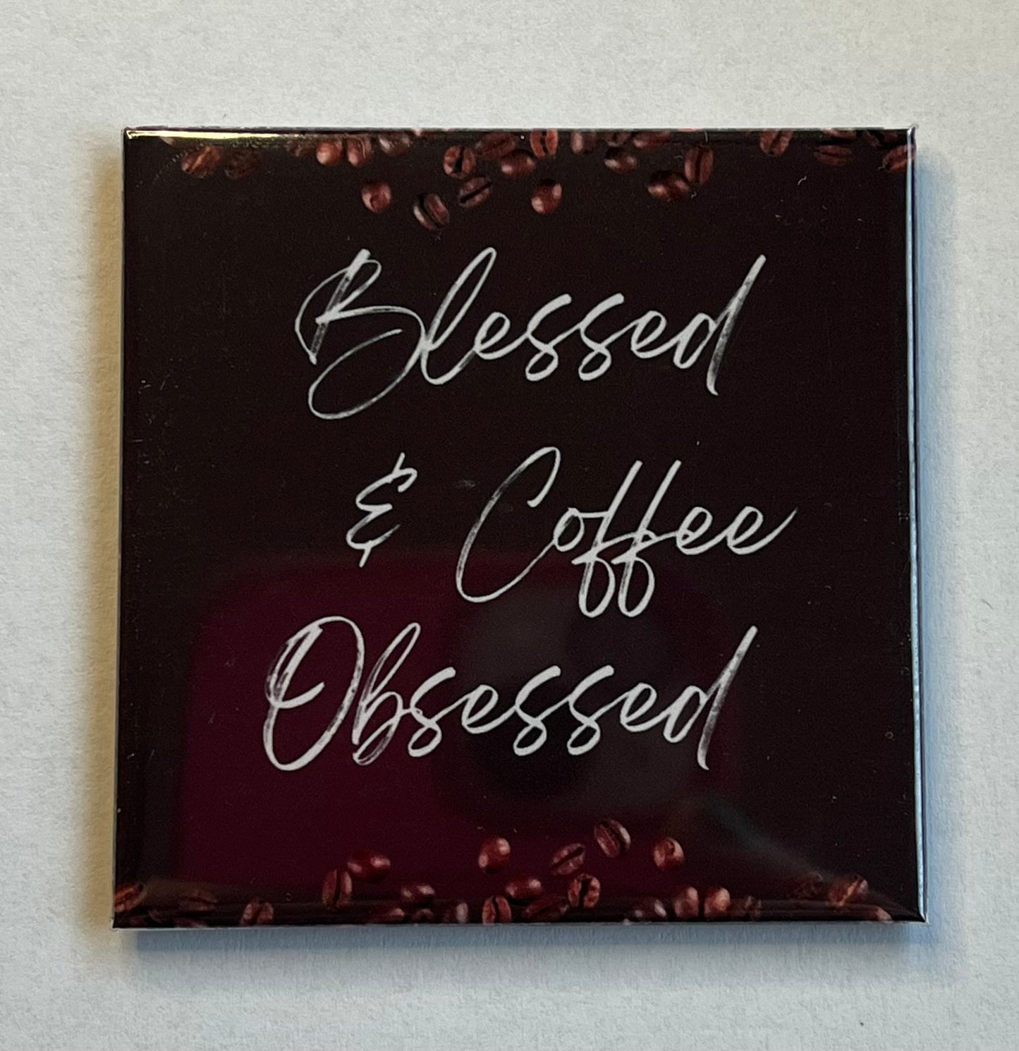 Christian coffee magnet with brown background and coffee beans reading Blessed and Coffee Obsessed