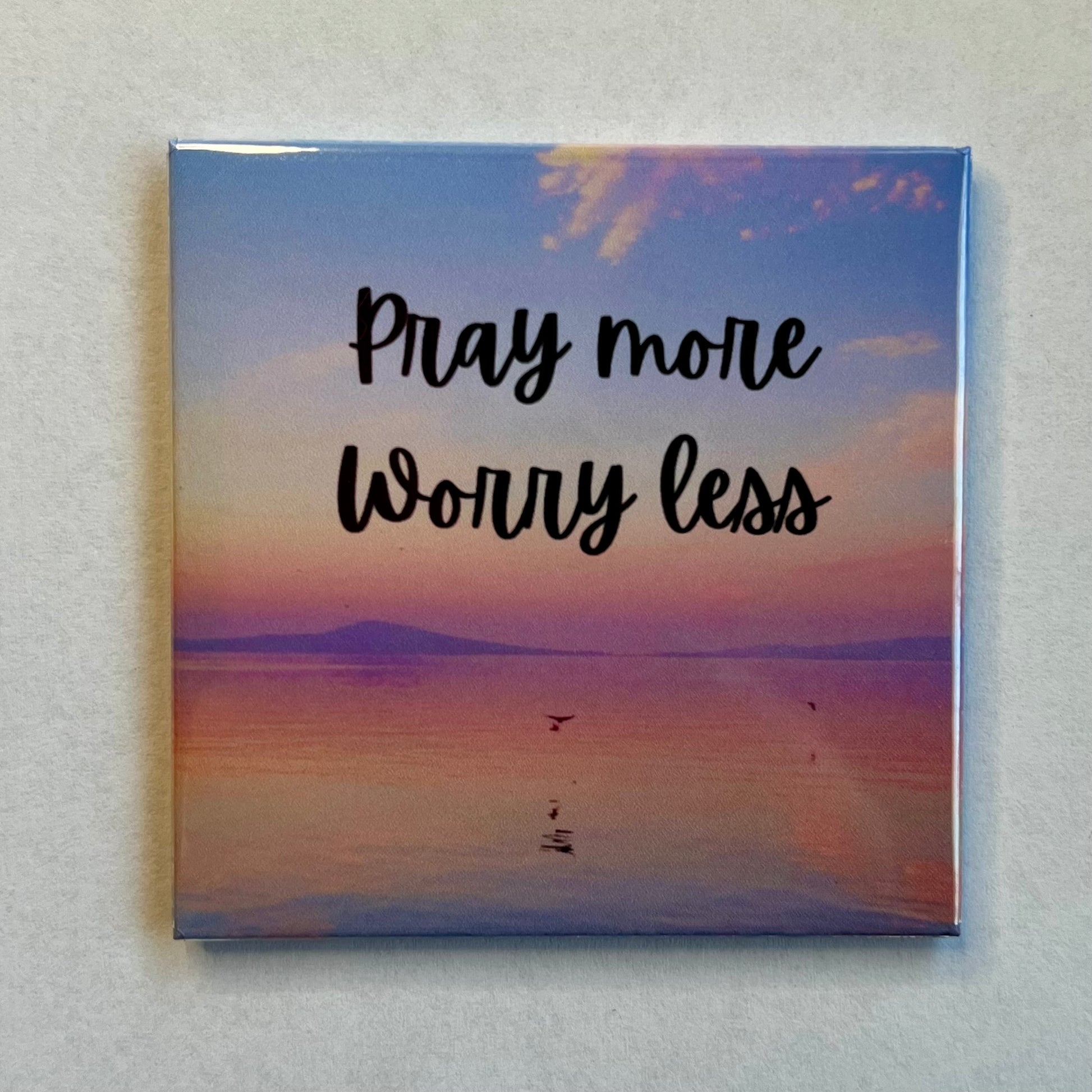 Faith-based magnet with lake sunset and mountains reading Pray More Worry Less